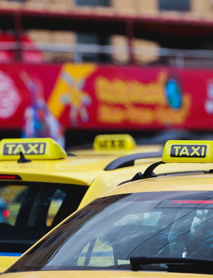 Yellow taxis lined up on a street in Athens, Greece, showcasing urban transportation.